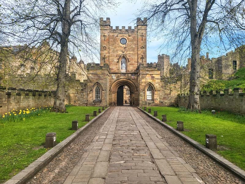 Entrance to Durham Castle with long walkway leading to Castle entrance. Just one of many things to do in Durham for couples