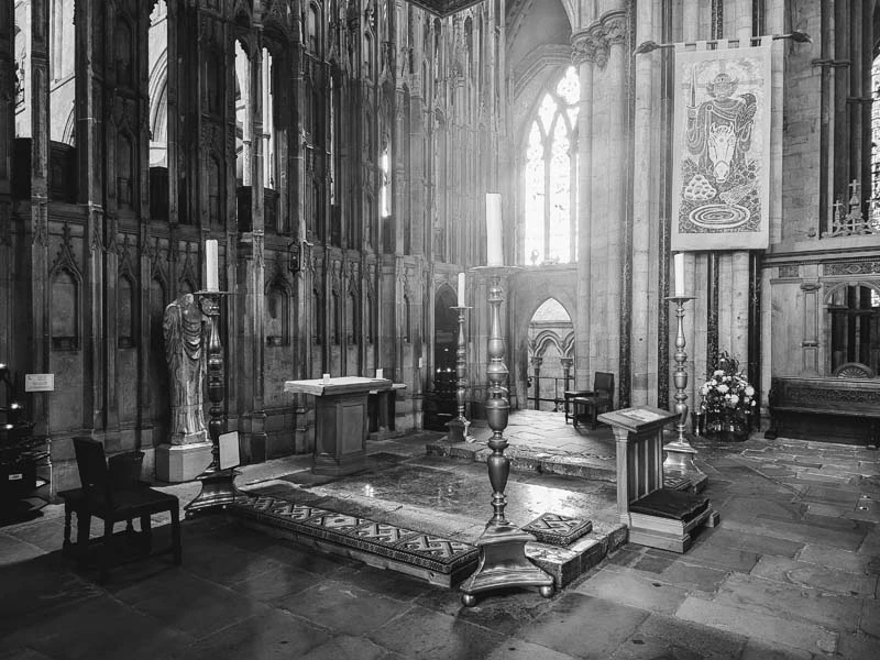 Black and white image. St Cuthbert's shrine in the ground and stained glass window in the middle left of photo. Just one of many things to do in Durham for couples