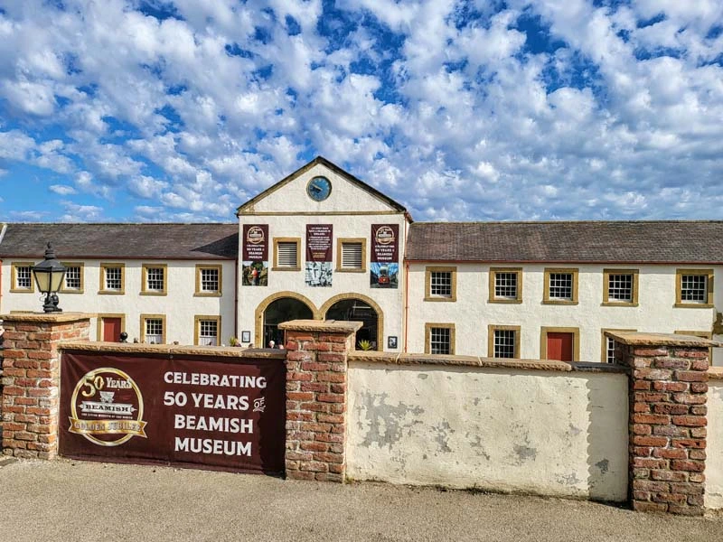 Exterior of Beamish Museum. Entrance building in background with 50 year commemorative banner in foreground. Just one of many things to do in Durham for couples