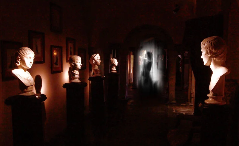 Ghostly image of a woman shrouded in white light in a dark corridor