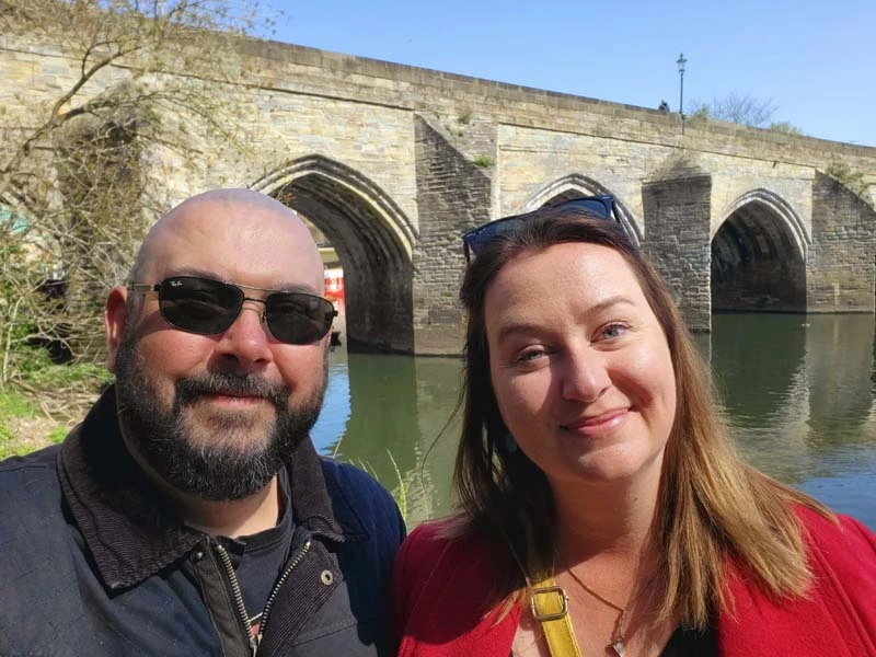 Photo of Russell and Roma from Roaming Required standing in front of Elvet Bridge in Durham. We hope that this post has shared some really helpful things to do in Durham for couples