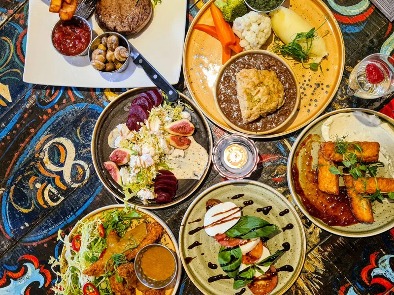 Flat lay photo of various food dishes on table in South Causey Inn