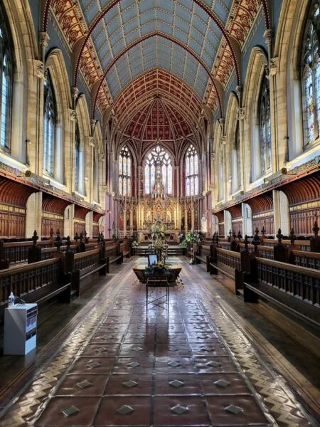 Interior shot of St Cuthbert's Chapel. Arching ceiling, stained glass windows to the left and right. Just one of many things to do in Durham for couples