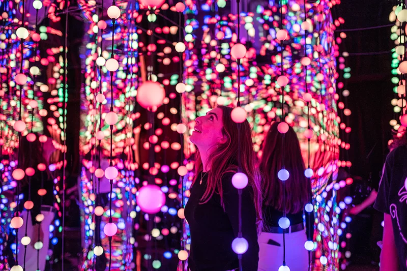 Girl in brightly coloured sparkly room